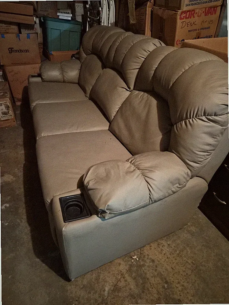 Lane, Tan, Reclining Vibrating Couch. Good condition with two small tears.